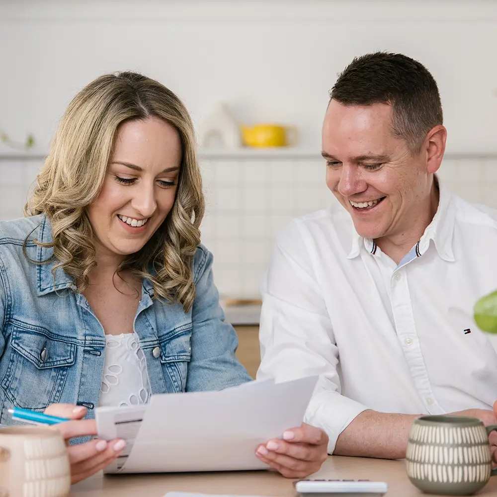 MyBudget clients Adam and Erin organising bills, supported by a debt management plan and budget planning in New Zealand.
