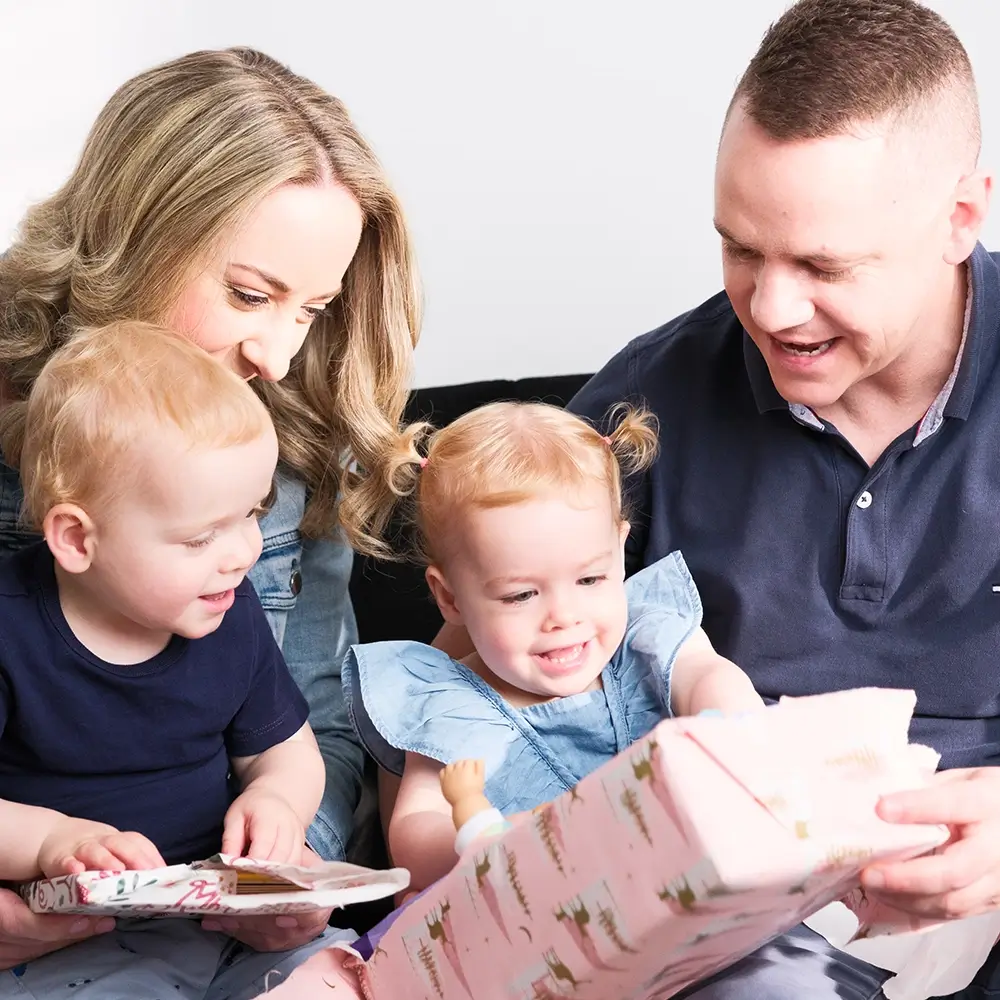 MyBudget clients Adam, Erin, and family enjoying gifts, thanks to successful budget planning and financial goals in New Zealand.