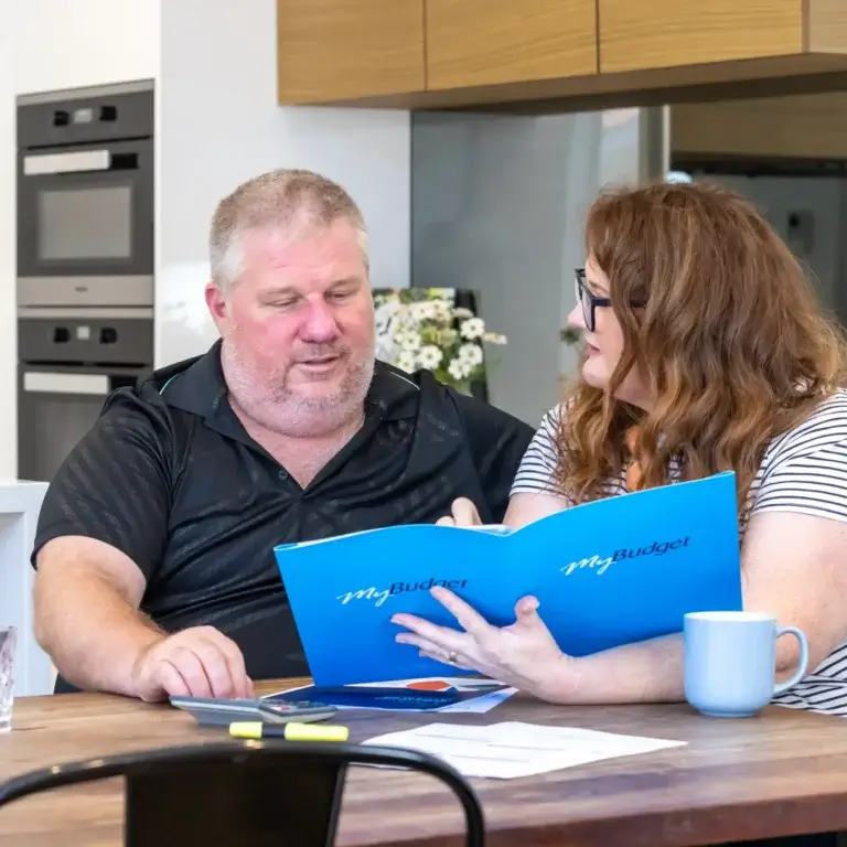 MyBudget clients Alyssa and Pete organising bills with a dedicated debt management plan and budget planning in New Zealand.